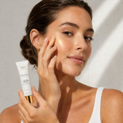 Applying Infusion d'Éclat to the face, natural highlighter by Hendiya®